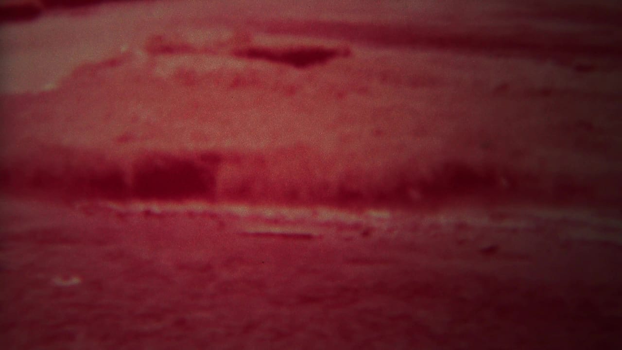Red-tinted dark river surface with faint bank lines and soft ripples.