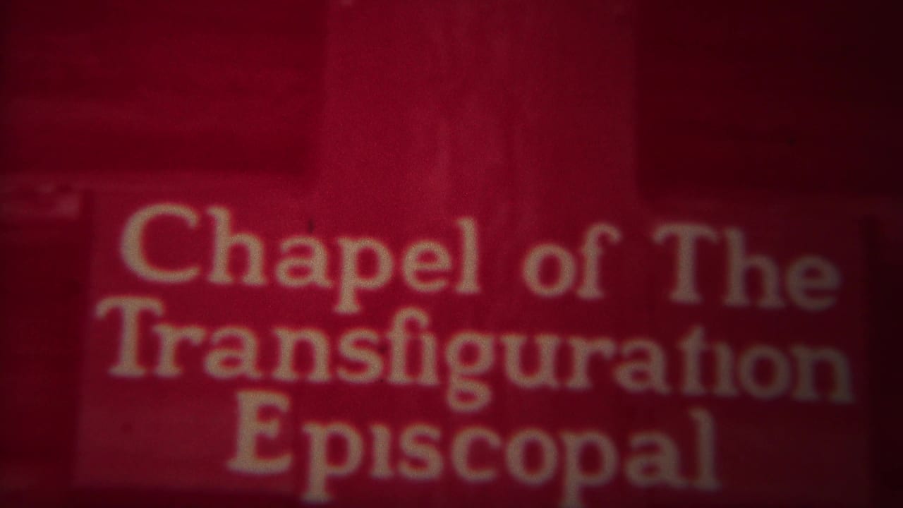 Chapel of the Transfiguration Episcopal sign with a red-tinted mountain-and-cross scene below.