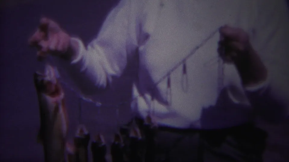 The final frame crops closer on the woman’s hands, white sweater, and fish stringer in the 1967 Yellowstone campground scene.