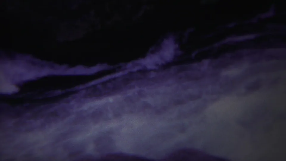 1967 Yellowstone 8mm frame showing a dark channel of fast water with streaks of white foam and film grain.