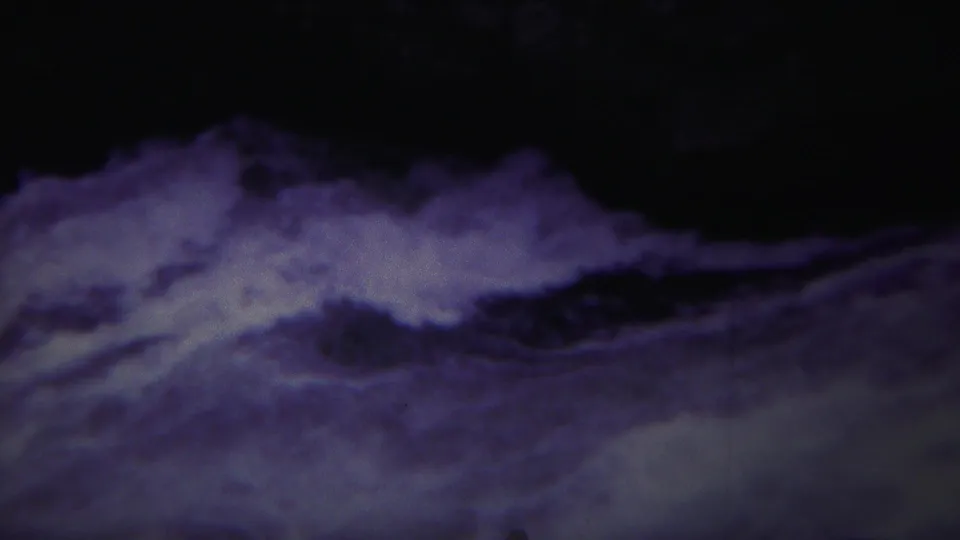 1967 Yellowstone 8mm frame of frothy white water and shadowed rapids with blue-purple archival color shift.