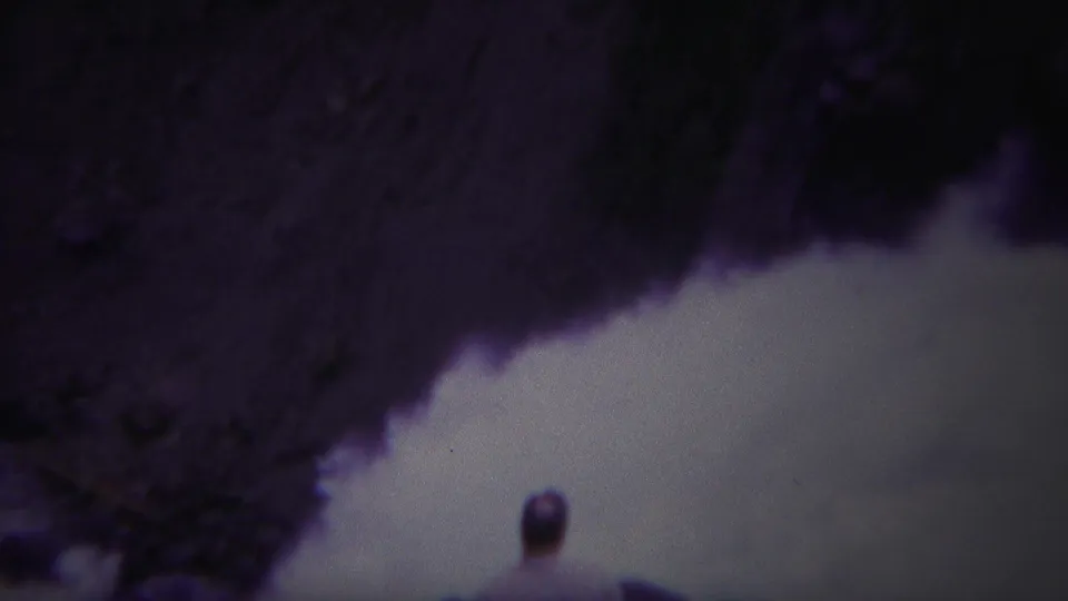 1967 Yellowstone 8mm frame with a small lone figure near the edge of turbulent white water.