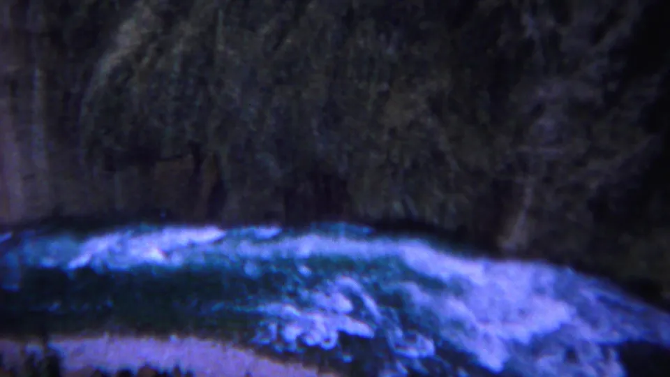 1967 Yellowstone 8mm frame showing blue-green river water and white foam below steep, dark canyon walls.