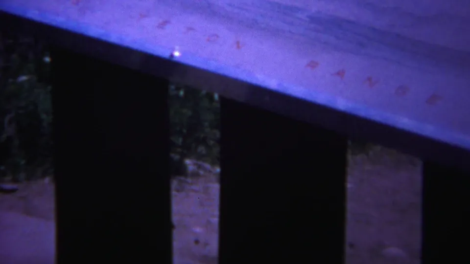 Color-shifted 8mm Yellowstone frame with a pale board crossing the top and dark vertical supports below.