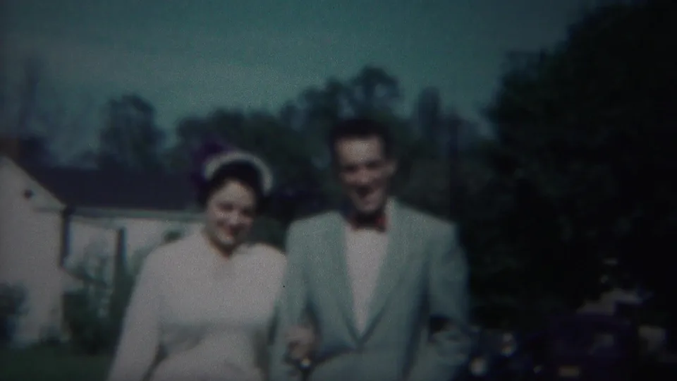 Newlywed couple in 1951 Westville, New Jersey, walks toward the camera in soft color 8mm footage.
