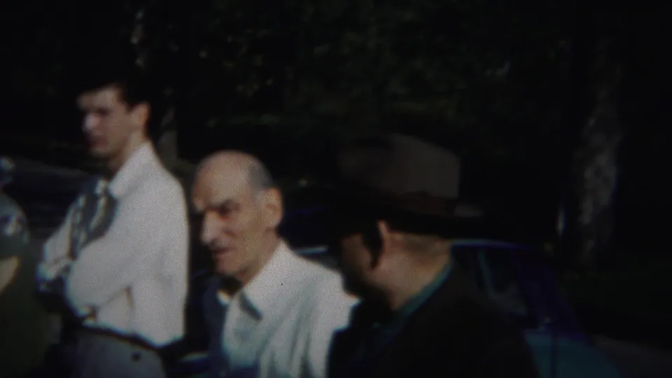 Westville, New Jersey 1951 footage shows an older man in a white shirt facing the camera as the fedora-wearing man turns aside.