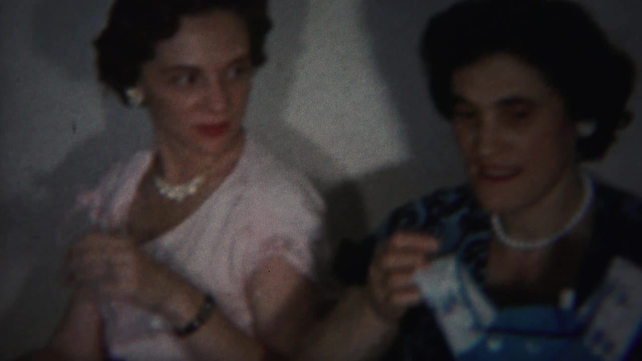 1951 Westville interior frame with two women in mid-century dresses and pearl jewelry turning toward one another during a gathering.