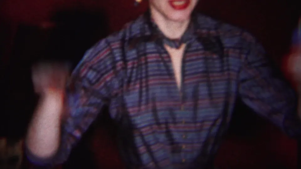 The woman in the 1951 Westville interior raises an arm in a lively gesture, with other people partially visible nearby.