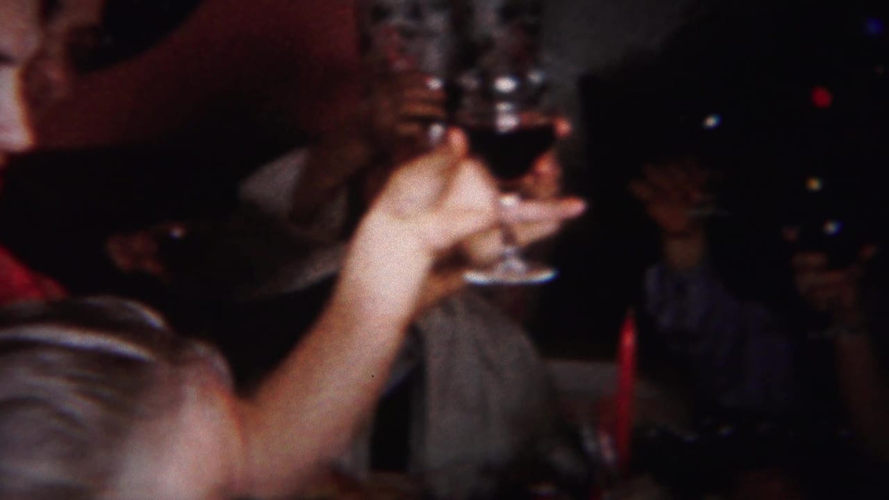 At the Westville gathering, adults appear to toast while a foreground hand holds a stemmed glass against a dark party background.