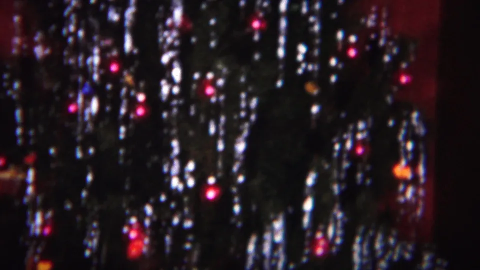 1951 Westville, New Jersey frame with reflective tinsel, small red lights, and a red interior backdrop around the tree.