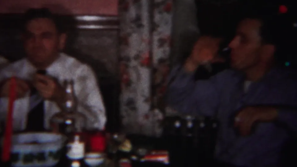 1951 Westville, New Jersey interior dining frame showing two men seated at a table, with one eating or drinking.