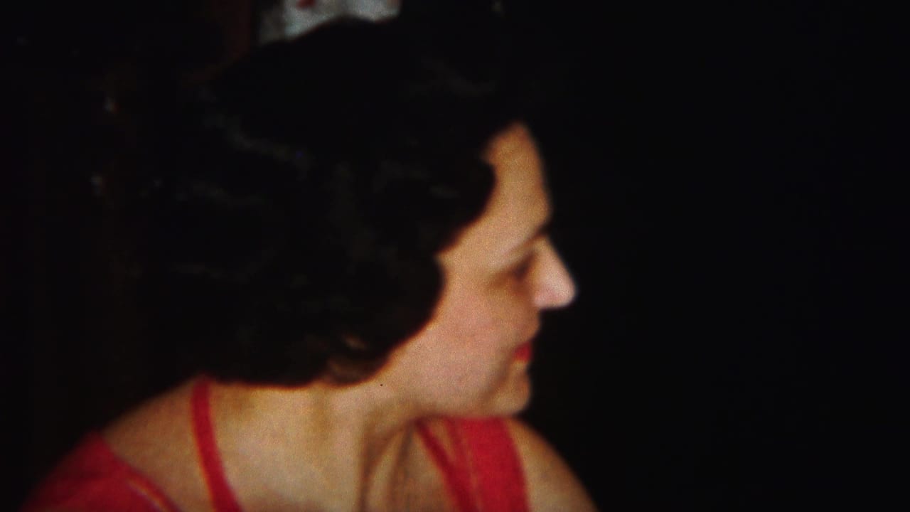 The woman in the red dress turns to the right, showing her profile in the 1951 Westville 8mm footage.