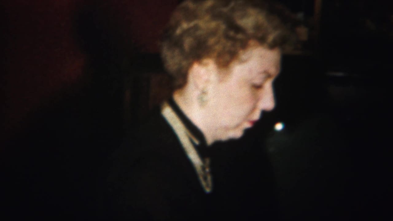 Woman in profile repeated in a dark indoor setting.
