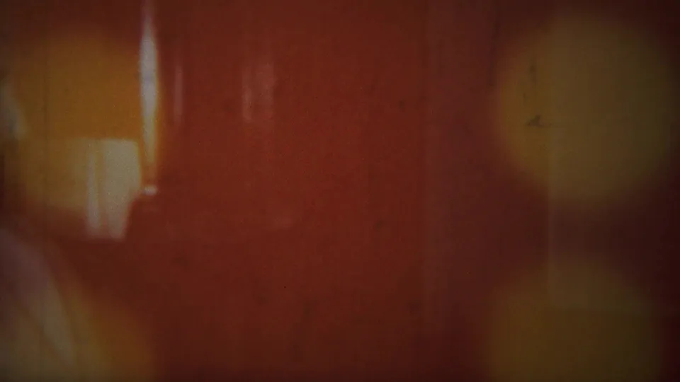 A reddish flare and blur from the 8mm footage obscure most of the Westville home interior near the end of the clip.