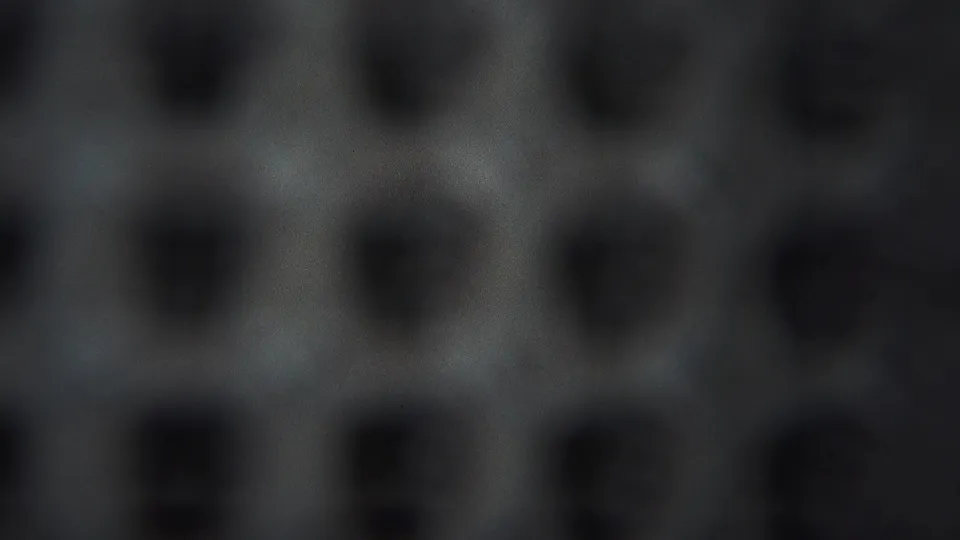 Final 1951 8mm frame showing a soft, repeated dark pattern over gray film texture, with no visible people, brands, or setting details.