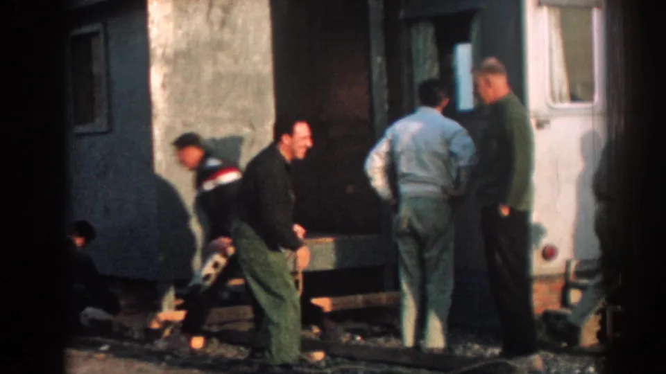 Adult men in Ephesus, Turkey appear to confer and work near rope, supports, and a portable structure in 1962 footage.