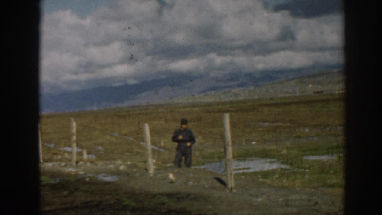 1962 8mm frame from Ephesus, Turkey showing a solitary man near fence posts in a remote field.