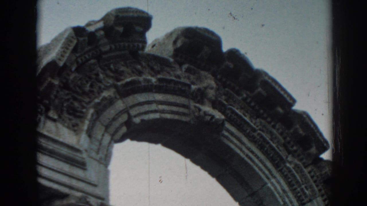 Vintage 8mm view of Ephesus stone architecture, with carved arch molding and weathered upper details.