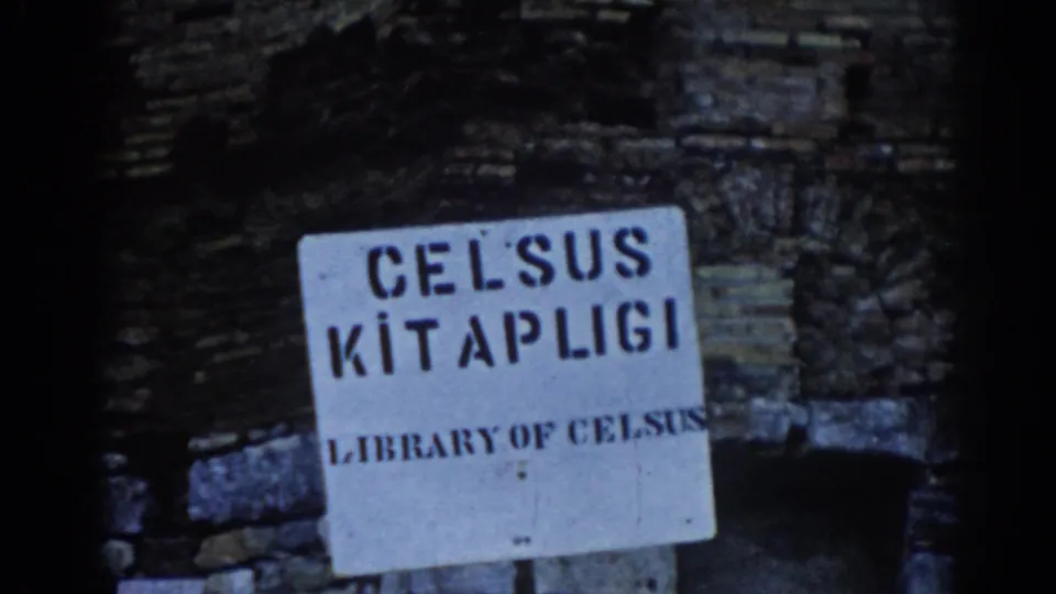 1962 Ephesus frame showing a white Celsus Kitapligi and Library of Celsus sign on a weathered stone wall.