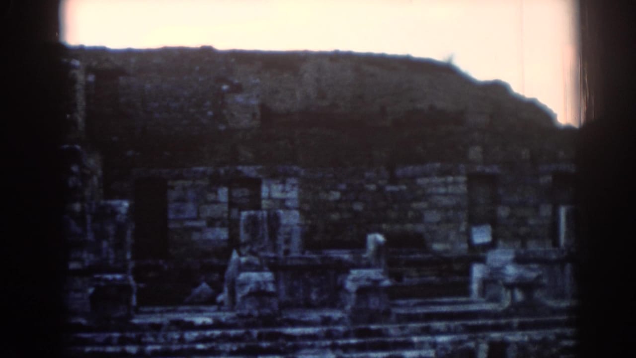 1962 Ephesus footage showing weathered stone ruins, steps, and columns after the camera moves away from the sign.