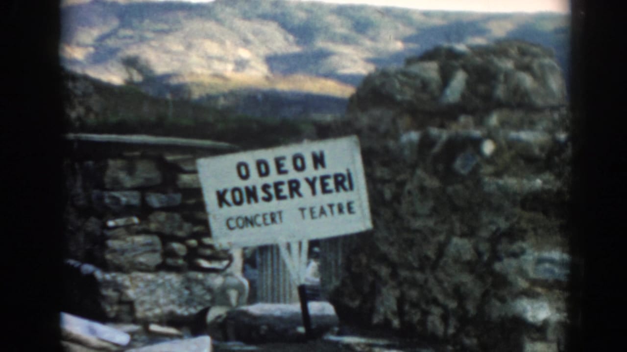 Odeon Konser Yeri sign framed by stone wall and rugged landscape.