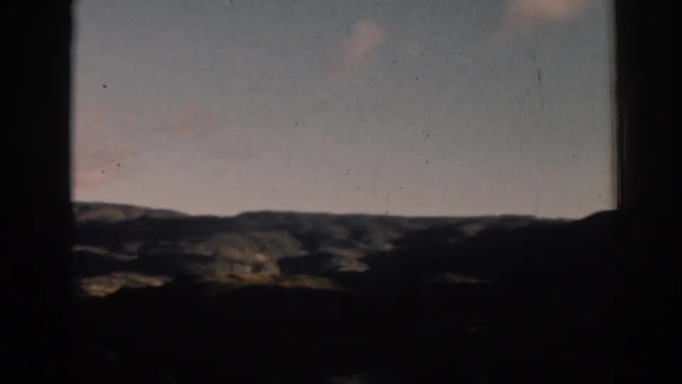 1962 Ephesus, Turkey scenic view with layered hills, subdued clouds, and heavy dark framing from the filmed window or film gate.