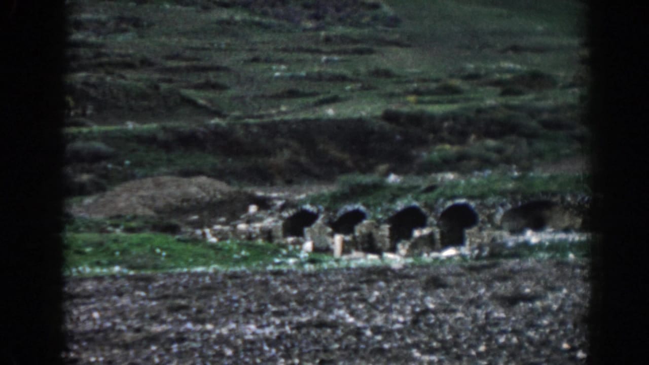Arched stone structures at Ephesus, Turkey, filmed from a distance on grainy 1962 8mm footage.