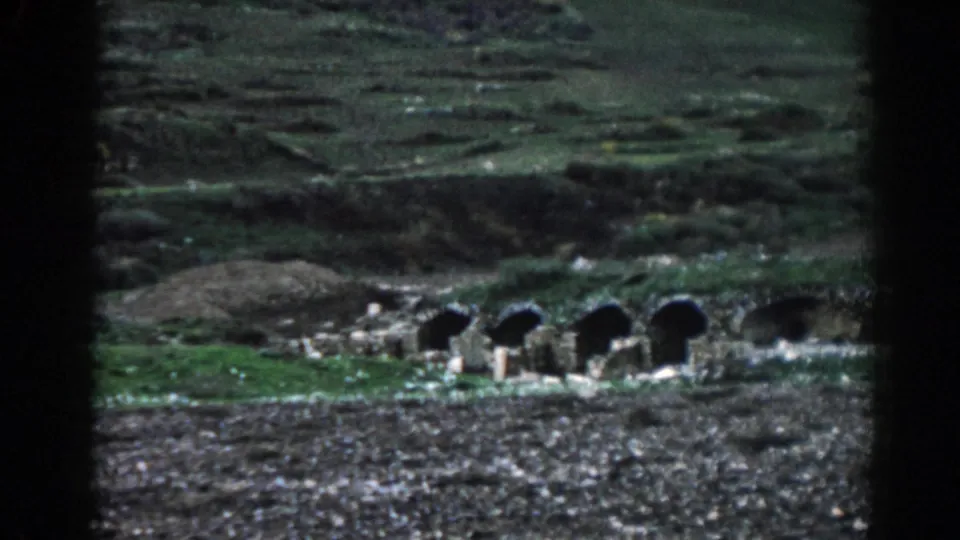 Arched stone structures at Ephesus, Turkey, filmed from a distance on grainy 1962 8mm footage.