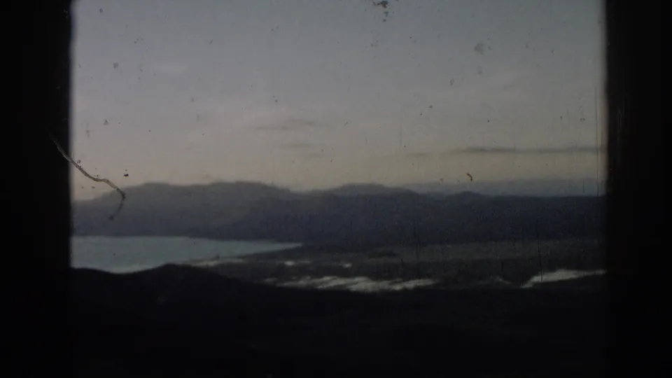 1962 Turkey travel footage shows distant ridges and a body of water framed by dark vertical edges.