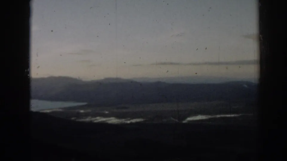 The 8mm frame shows a muted 1962 view of water, valley land, and distant hills in the Ephesus area.