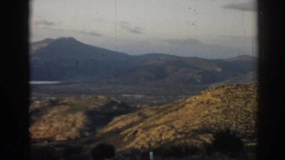 Final 8mm frame from near Ephesus, Turkey, showing a darker mountain peak behind dry rolling hills and sparse vegetation.