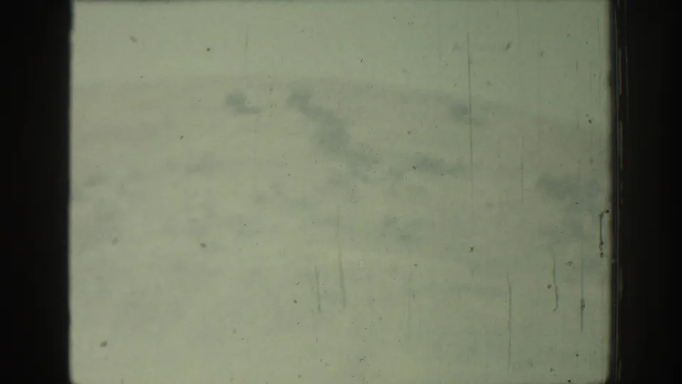 Final Rhodes travel frame is nearly obscured by pale fading, scratches, and aged-film marks, with no distinct people or landmarks visible.