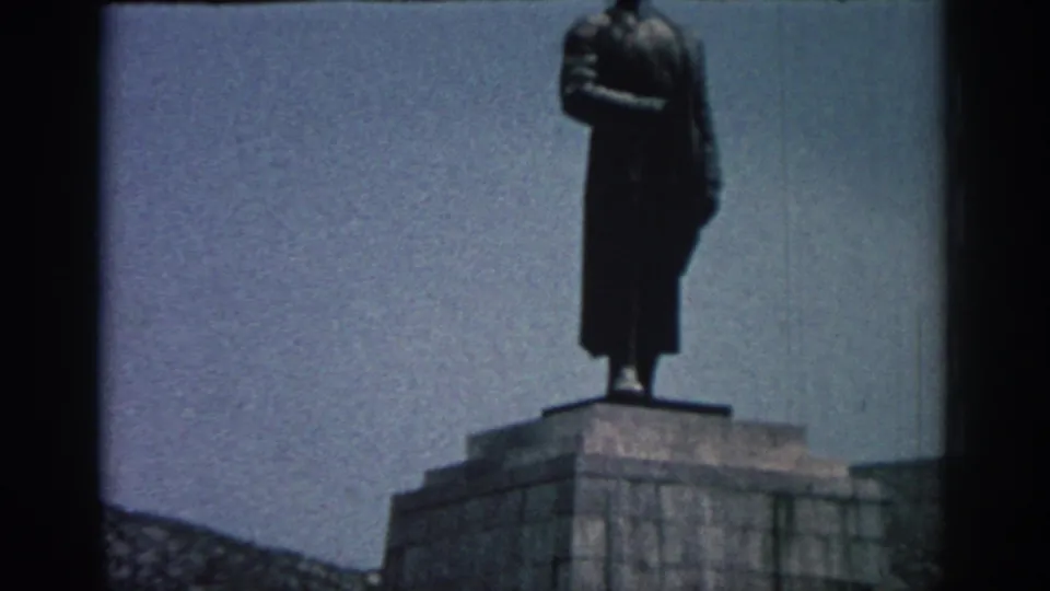 Large male statue on a stone pedestal, filmed as a Rhodes-area landmark in 1962 home-movie footage.