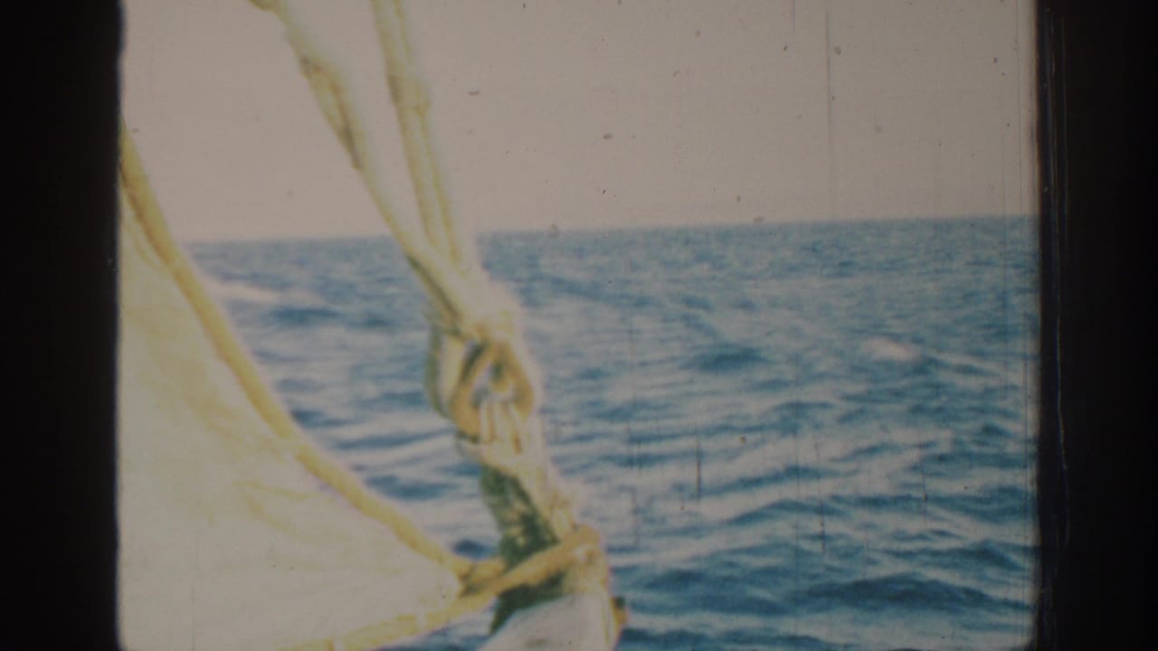 1962 Rhodes, Greece 8mm frame showing boat rigging and rope against open blue water and a pale horizon.