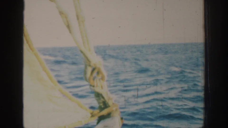 1962 Rhodes, Greece 8mm frame showing boat rigging and rope against open blue water and a pale horizon.