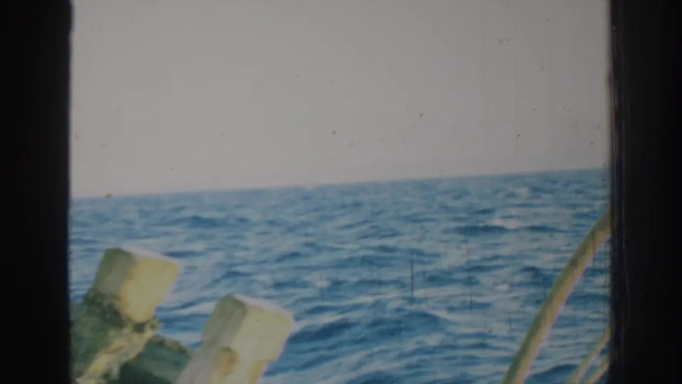 Open water near Rhodes, Greece, framed by pale wooden boat pieces and vertical dark 8mm film borders.
