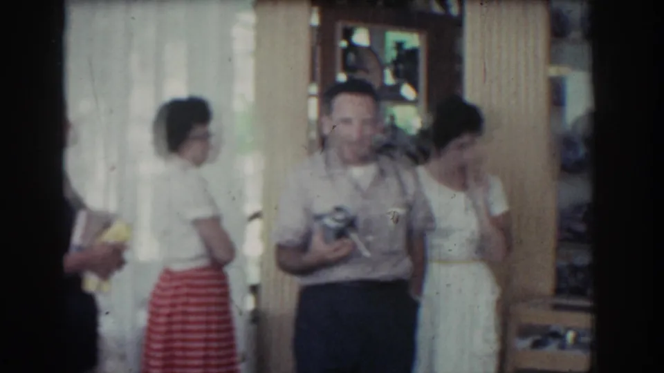 Adults gather near the shop entrance, including a woman in a striped skirt and a man in a light shirt.
