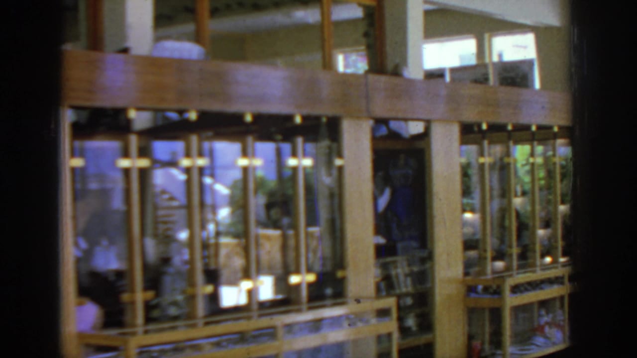 Wooden glass display cases inside a restaurant or hotel space.