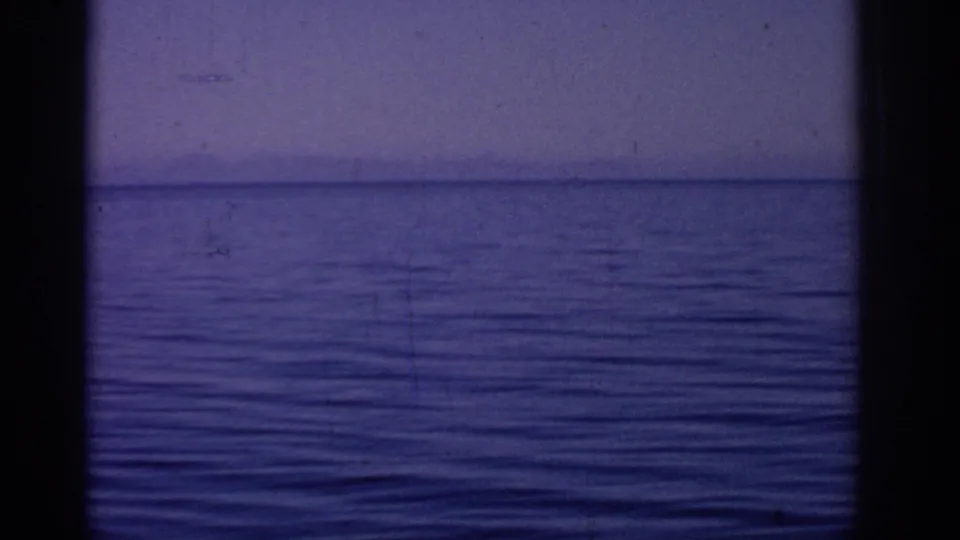 1962 Rhodes 8mm frame emphasizing rippled blue sea and horizon after the fortress drifts mostly out of view.