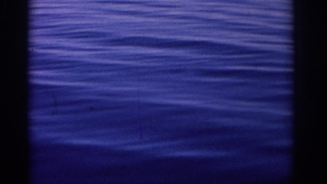Blue rippled water seen through dark 8mm frame borders.