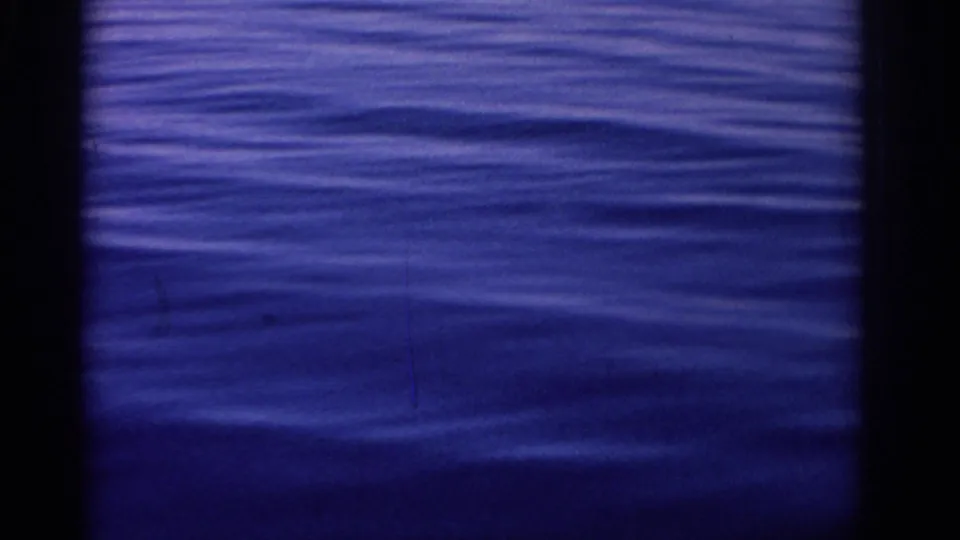1962 Rhodes, Greece 8mm frame showing blue ocean ripples with dark film-strip edges and visible grain.