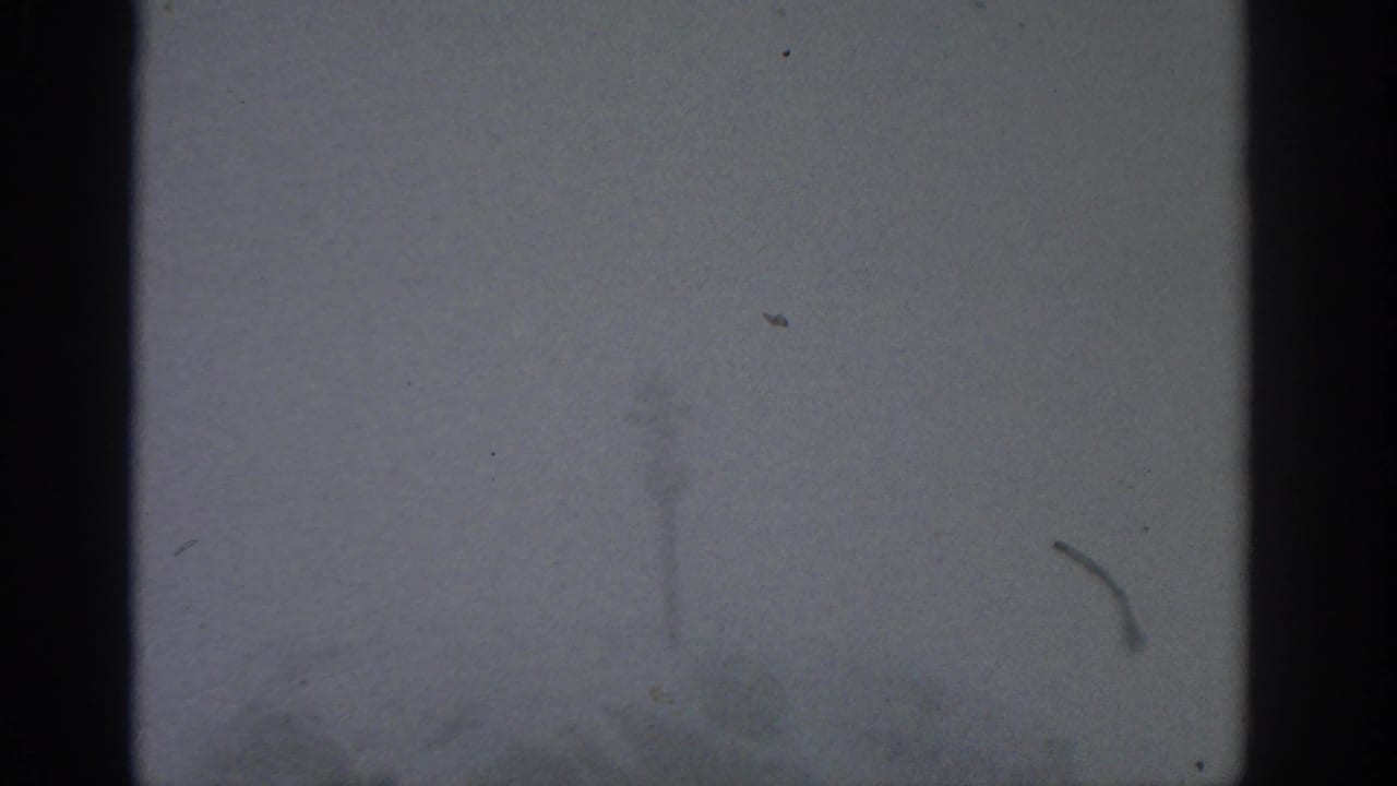 Foggy pale exterior with a dark vertical edge and faint horizon shapes.