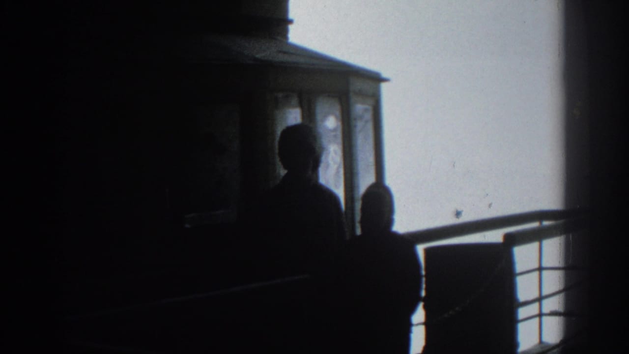 Two dark figures are seen near tram windows, with railings against a pale sky.