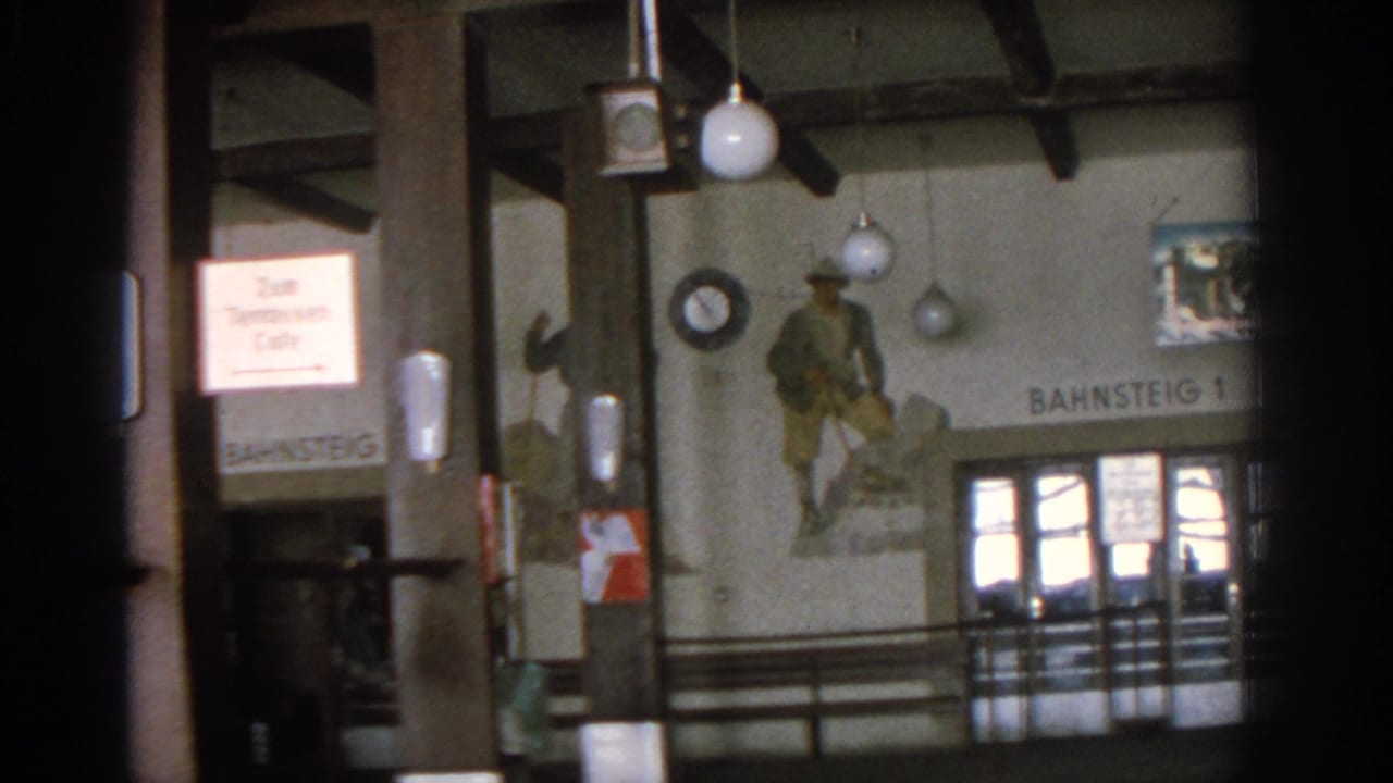 Interior with timber posts, hanging globe lights, mural, cafe sign, and Bahnsteig 1 lettering.