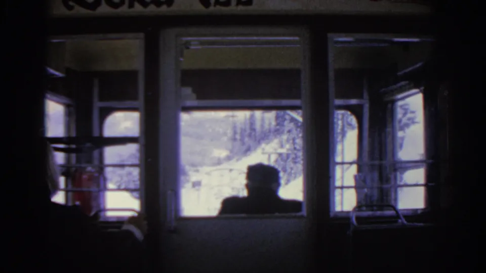 The final frame shows the Munich train interior, a seated passenger silhouette, and snowy rail-side scenery beyond the windows.