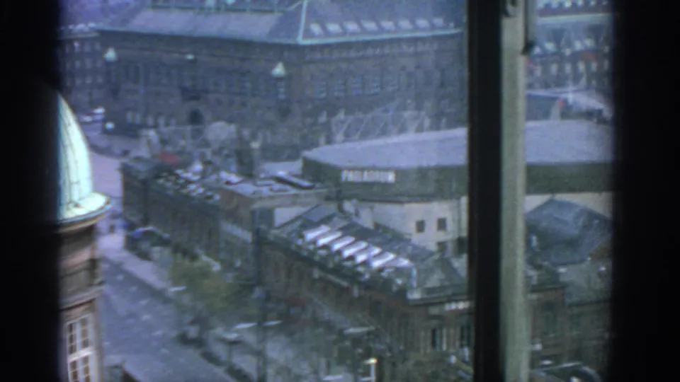1963 Warsaw street scene from above, with the Palladium sign, rooftops, traffic routes and window framing visible.