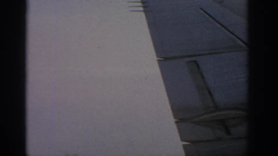1963 Warsaw frame with a plain pale wall, a dark blue-gray architectural plane, and a black vertical edge crossing the view.