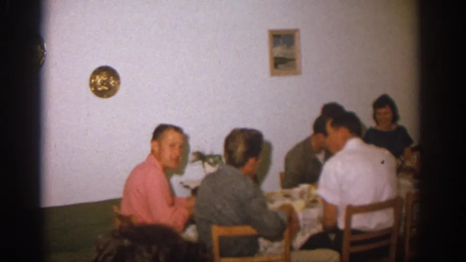 A later angle of the Zurich dinner shows seated adults at the table in a private room with wall decor behind them.