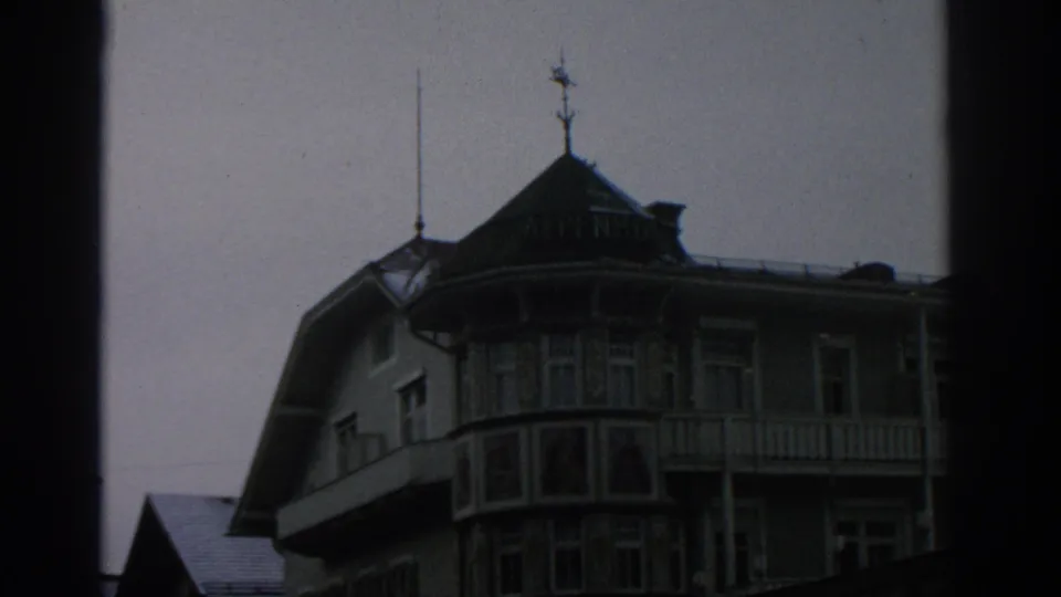 1963 Switzerland travel frame with an alpine-style hotel facade, ornate balcony details, and visible ALPENHOF roof lettering.