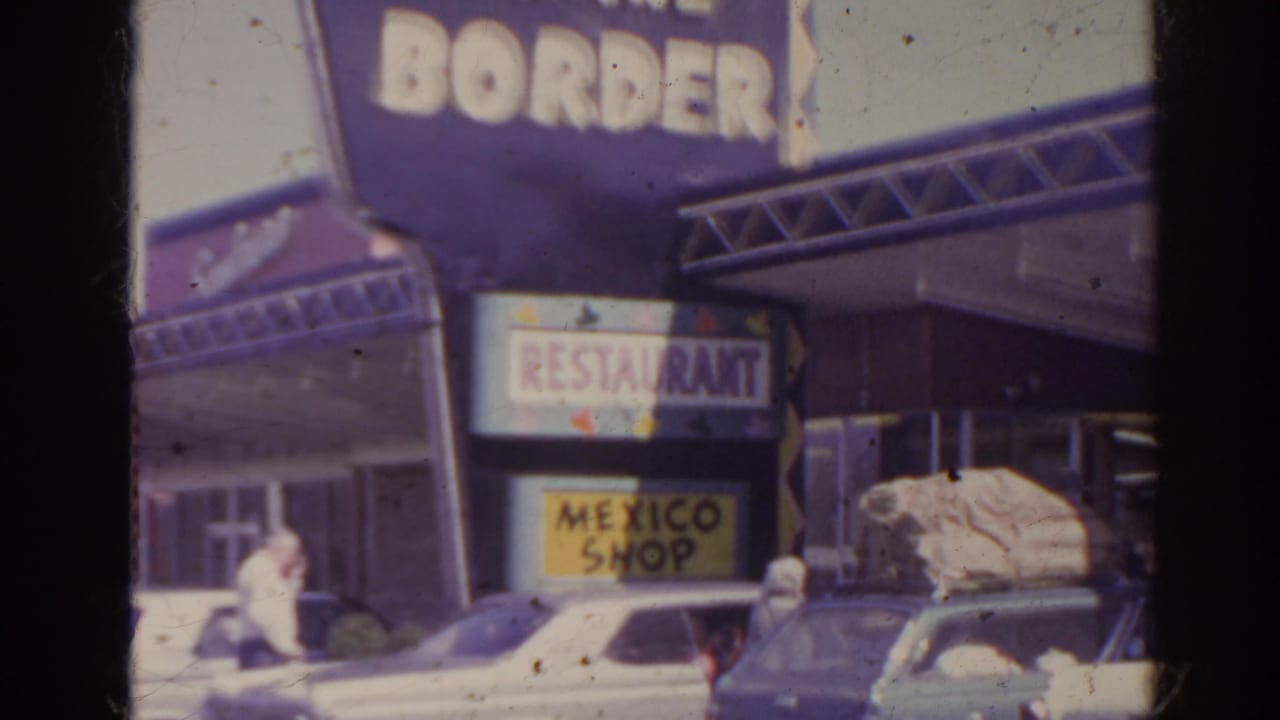 Roadside restaurant exterior with Border sign, Mexico Shop sign, parked cars, and a person near the entrance.
